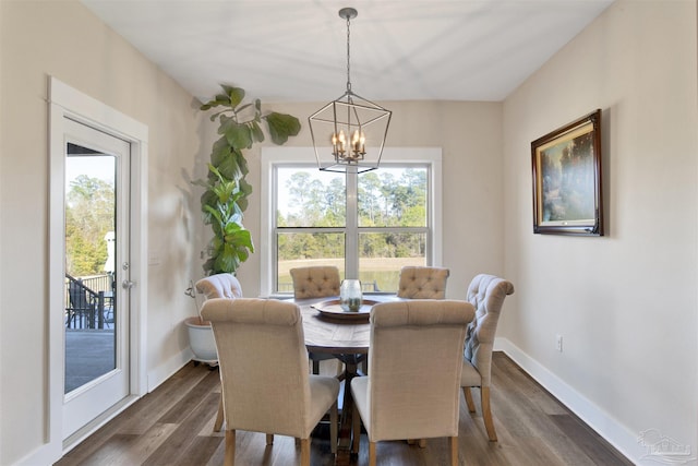 dining room with dark wood-type flooring and a chandelier