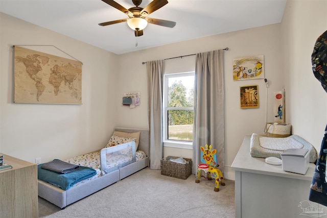 bedroom featuring ceiling fan and carpet