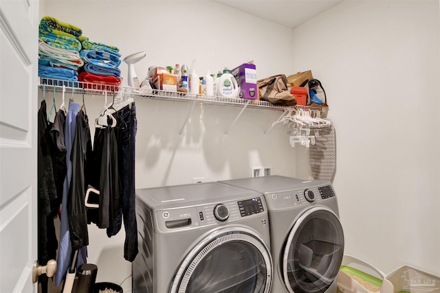 clothes washing area featuring independent washer and dryer