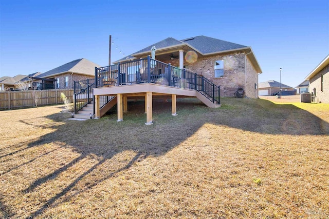 rear view of house with a wooden deck, central AC unit, a lawn, and ceiling fan