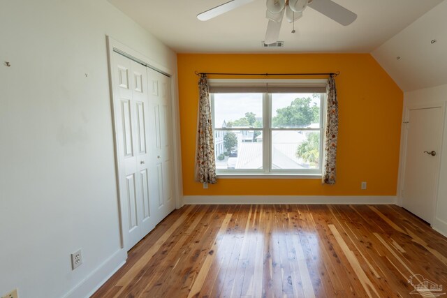 431 E Zarragossa St Unit B, Pensacola, FL 32502 - unfurnished bedroom featuring wood-type flooring, vaulted ceiling, baseboards, a closet, and a ceiling fan
