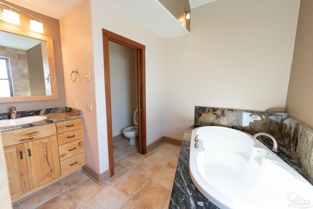 431 E Zarragossa St Unit B, Pensacola, FL 32502 - full bathroom with vanity, a garden tub, baseboards, toilet, and tile patterned floors
