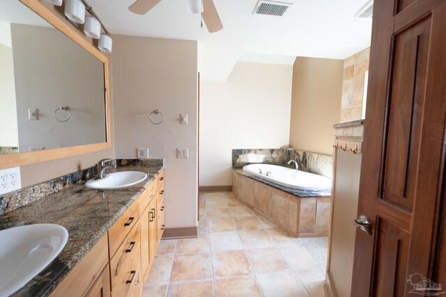 431 E Zarragossa St Unit B, Pensacola, FL 32502 - bathroom with double vanity, a bath, a ceiling fan, tile patterned flooring, and baseboards