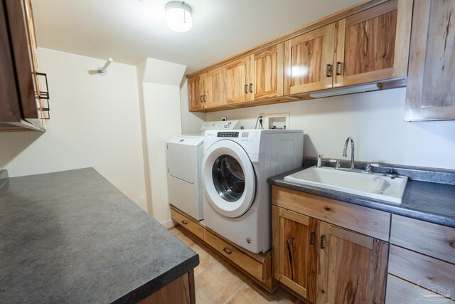 431 E Zarragossa St Unit B, Pensacola, FL 32502 - washroom with washing machine and dryer, cabinet space, and light tile patterned floors