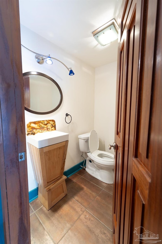 431 E Zarragossa St Unit B, Pensacola, FL 32502 - bathroom featuring toilet, vanity, baseboards, and tile patterned floors