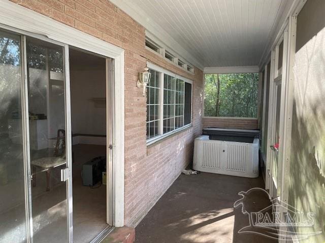 unfurnished sunroom featuring radiator heating unit