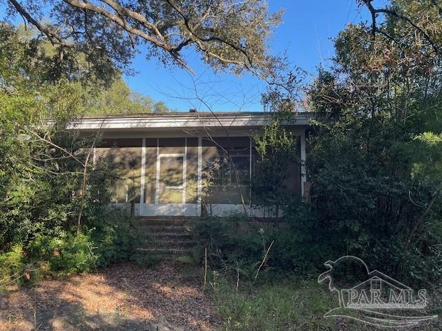 view of side of home with a sunroom