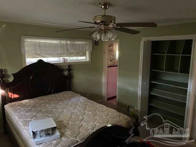 bedroom with ceiling fan and a closet