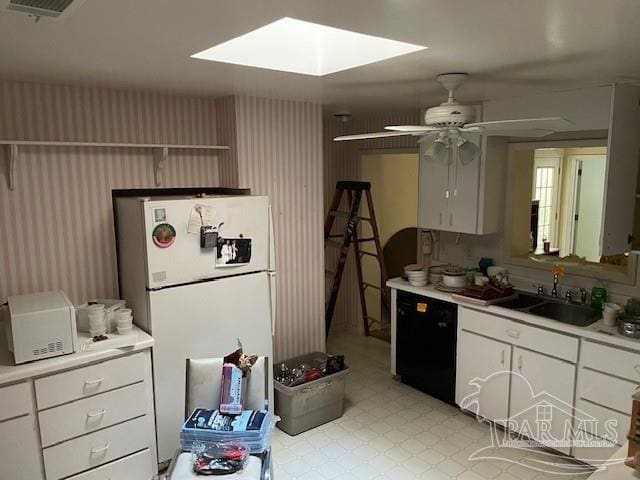 kitchen with white cabinets, white refrigerator, ceiling fan, and sink