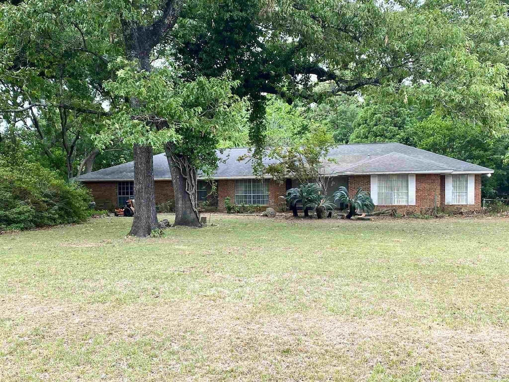 single story home with brick siding and a front lawn