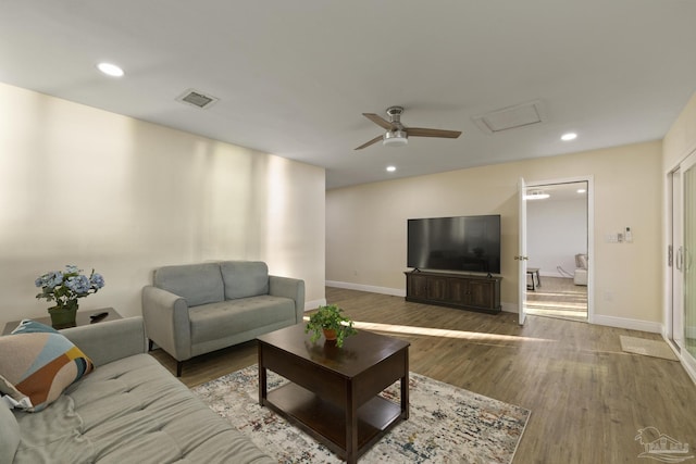 living room featuring hardwood / wood-style flooring and ceiling fan