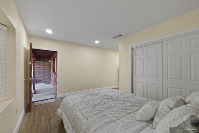 bedroom featuring hardwood / wood-style flooring and a closet