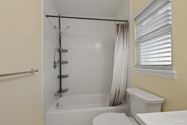 bathroom featuring toilet and shower / bath combo with shower curtain