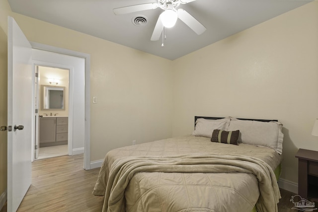 bedroom featuring ceiling fan, sink, and light hardwood / wood-style floors