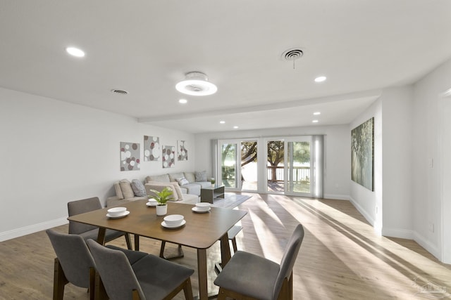 dining space featuring light wood-type flooring