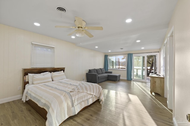 bedroom with access to exterior, hardwood / wood-style flooring, and ceiling fan