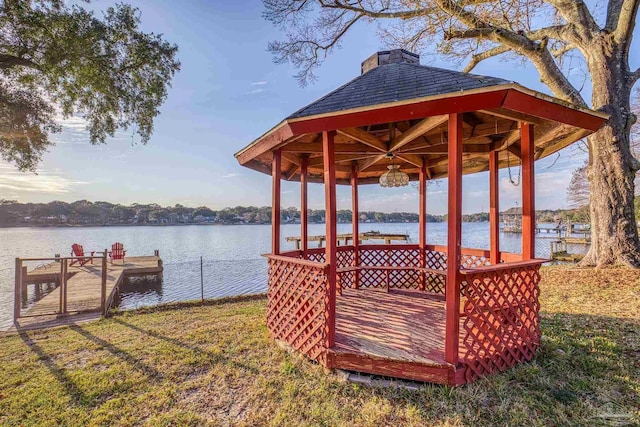 dock area featuring a gazebo, a lawn, and a water view