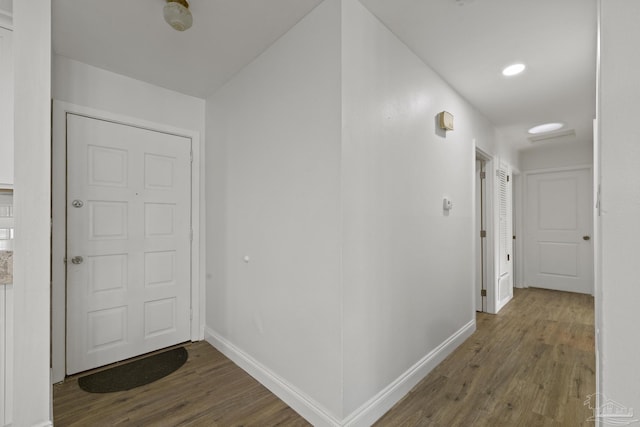 hall with hardwood / wood-style floors