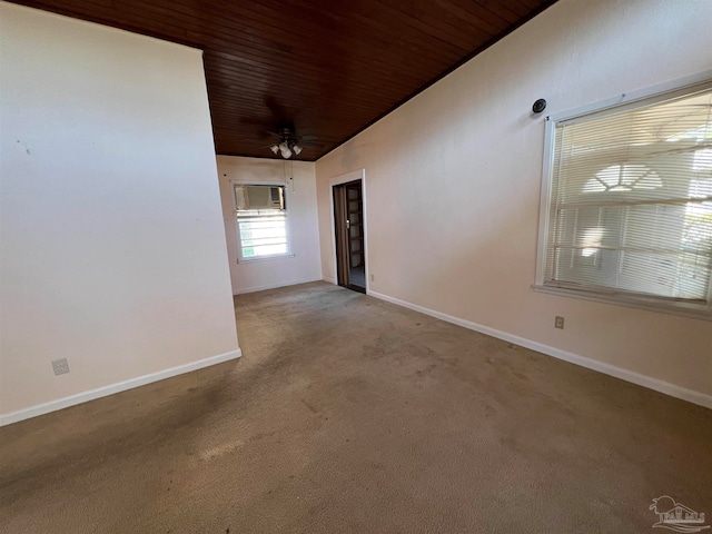 empty room with ceiling fan, wooden ceiling, vaulted ceiling, and light colored carpet