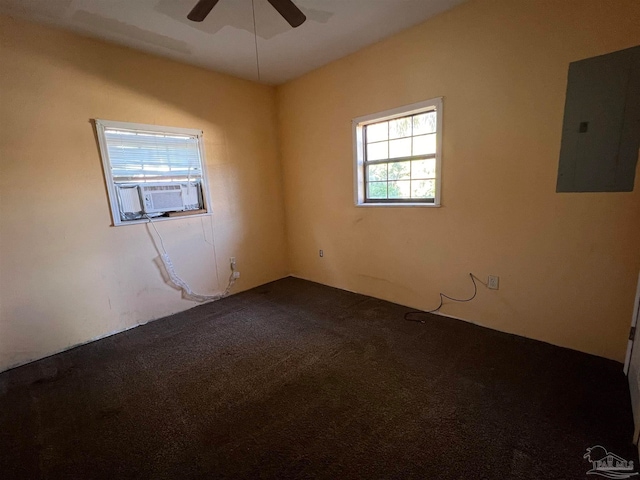 carpeted empty room featuring ceiling fan, cooling unit, and electric panel