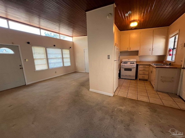 kitchen with light tile patterned floors, wooden ceiling, sink, and white range with gas stovetop