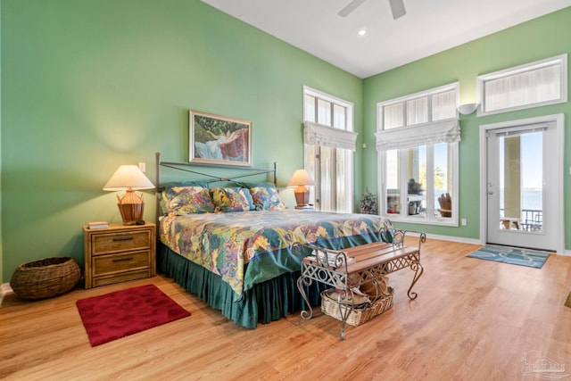 bedroom with hardwood / wood-style flooring, access to outside, and ceiling fan