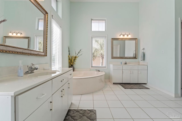 bathroom with a tub to relax in, tile patterned floors, and vanity