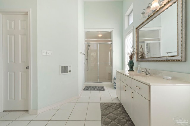 bathroom featuring vanity, a shower with door, and tile patterned floors