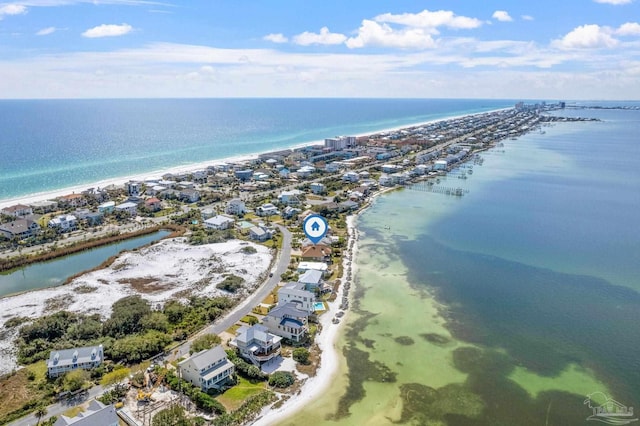 aerial view with a water view and a beach view