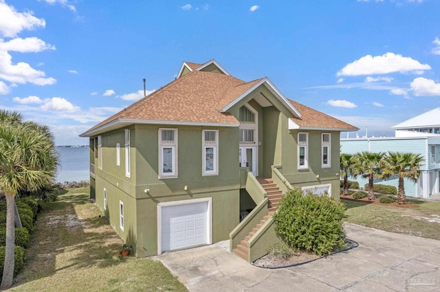 view of front of house with a water view and a garage