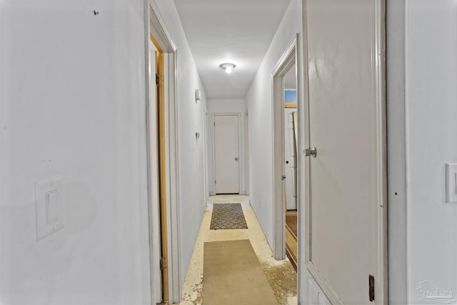 hallway featuring concrete flooring