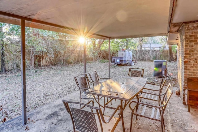 view of patio / terrace featuring a fenced backyard, central AC, and outdoor dining space