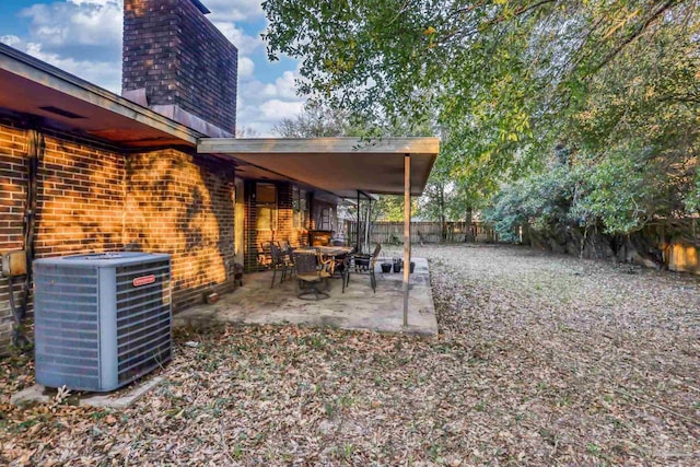 view of yard with a fenced backyard, central AC unit, and a patio