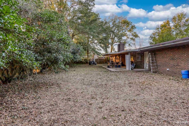 view of yard featuring a patio and fence