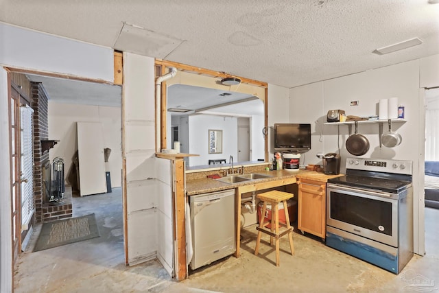 kitchen featuring stainless steel electric range, a sink, a textured ceiling, concrete floors, and dishwasher