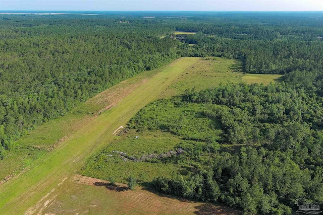 drone / aerial view with a wooded view
