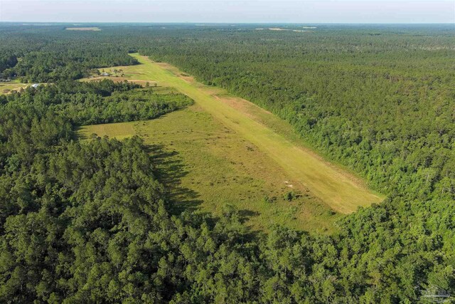 drone / aerial view featuring a wooded view