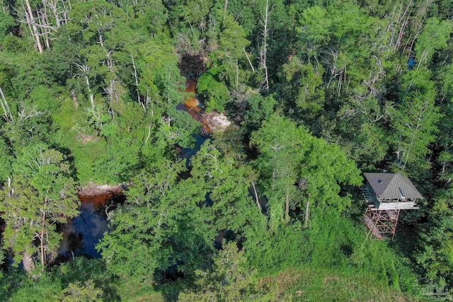 bird's eye view featuring a wooded view