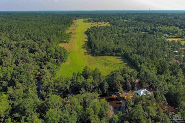 drone / aerial view featuring a view of trees