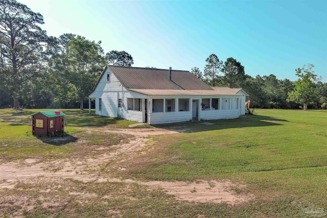 exterior space with a lawn and metal roof
