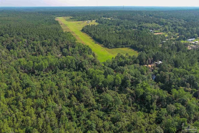 drone / aerial view featuring a wooded view