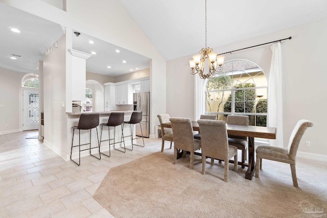 dining area with baseboards, high vaulted ceiling, recessed lighting, and a notable chandelier