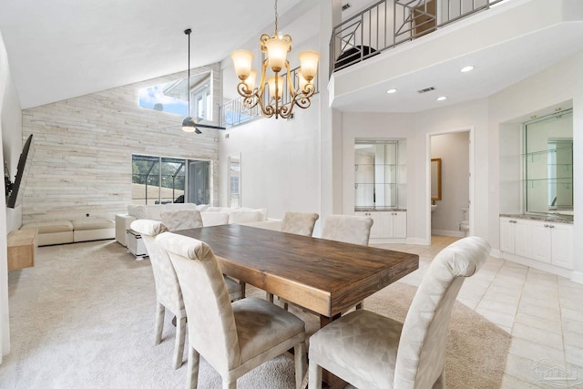 dining area featuring a towering ceiling, light tile patterned floors, visible vents, and recessed lighting