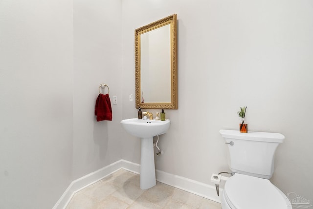 bathroom featuring toilet and baseboards