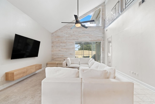 living area featuring high vaulted ceiling, plenty of natural light, visible vents, and a ceiling fan