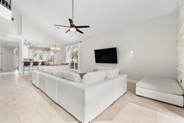 living room featuring baseboards, light tile patterned flooring, ceiling fan with notable chandelier, high vaulted ceiling, and recessed lighting