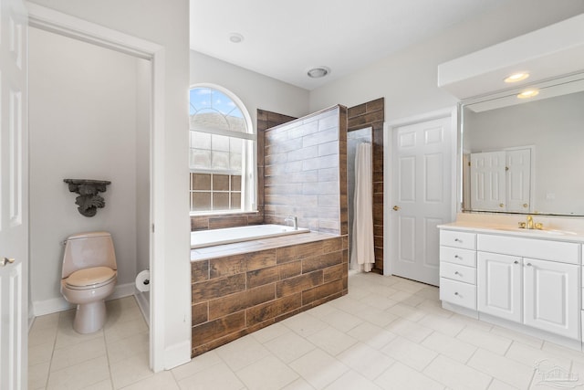 full bathroom featuring a garden tub, toilet, vanity, baseboards, and tile patterned floors