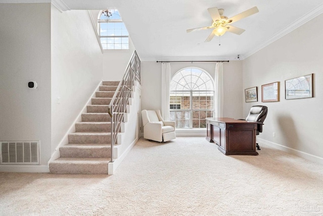 office area featuring light carpet, a healthy amount of sunlight, visible vents, and ornamental molding