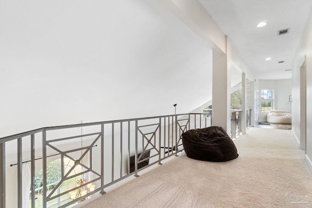 corridor featuring carpet floors, an upstairs landing, visible vents, and recessed lighting