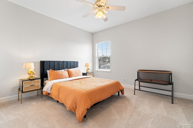 carpeted bedroom with ceiling fan and baseboards